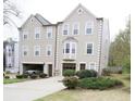 Exterior view of townhomes with driveways, garages and manicured landscaping at 988 Vintage Pointe Dr, Lawrenceville, GA 30044