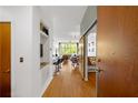 Hallway with hardwood floors and a barn door leading to an open concept living and dining area at 130 Arizona Ne Ave # 214, Atlanta, GA 30307