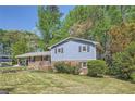 Well-maintained two-story home featuring light blue siding, brick accents, and a lush green lawn at 1461 Sanden Ferry Dr, Decatur, GA 30033