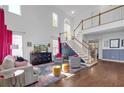 Bright, open living room with tall ceilings, large windows, hardwood floors, and stylish decor at 1549 Tappahannock Trl, Marietta, GA 30062