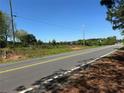 Scenic road frontage with clear sightlines and utility access points, ready for development opportunities at 2085 Jones Phillips Rd, Dacula, GA 30019