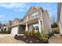 Charming two-story home featuring stone accents, well manicured landscaping, and covered front porch at 214 Gaston Ct, Canton, GA 30115