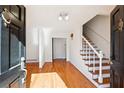 Bright entryway featuring hardwood floors, a staircase and a white door at 244 Saint Patrick Sw Dr, Mableton, GA 30126
