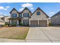 Charming two-story home with a large two-car garage and well-manicured front lawn at 4585 Woodland Bank Blvd, Buford, GA 30518