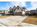 Spacious two-story home featuring a three-car garage and beautiful brick and stone accents at 4585 Woodland Bank Blvd, Buford, GA 30518