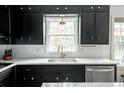 Modern kitchen with sleek black cabinets, stainless steel appliances, and bright countertops at 1477 Brawley Ne Cir, Brookhaven, GA 30319