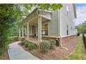 Charming exterior features a welcoming porch and well-maintained landscaping at 201 Saddle Rd, Alpharetta, GA 30009