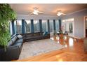 Bright living room with hardwood floors, furniture, and a view of wooded outdoor space at 2815 Cambridge Hills Rd, Cumming, GA 30041