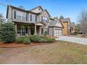 Charming two-story home with brick accents, a two-car garage, and a covered porch at 3541 Stoneleigh Walk, Lithonia, GA 30038