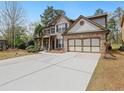 Charming two-story home with brick accents, a two-car garage, and a long driveway at 3541 Stoneleigh Walk, Lithonia, GA 30038