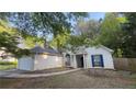A charming one-story home with a stucco exterior, attached garage, and well-maintained landscaping at 209 Southerness Ct, Stockbridge, GA 30281