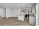 Modern kitchen with gray cabinets, granite countertops, and stainless steel appliances at 209 Weldon, Mcdonough, GA 30253