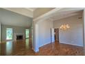 Spacious living room featuring gleaming hardwood floors, a charming fireplace, and an elegant chandelier above the dining area at 225 Mountain Vista Blvd, Canton, GA 30115
