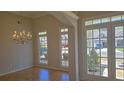 Elegant formal living room featuring hardwood flooring, crown molding, a chandelier and a view to the front yard at 225 Mountain Vista Blvd, Canton, GA 30115