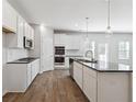 Stylish kitchen with granite island, stainless appliances, lots of counter space and bright lighting at 358 Orwell Dr, Social Circle, GA 30025