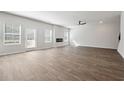 Spacious living room with lots of natural light and dark laminate flooring at 358 Orwell Dr, Social Circle, GA 30025