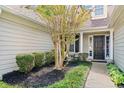 Inviting entrance with a landscaped yard, mulch, and decorative shrubs creating a welcoming feel at 1483 Chamirey Sw Dr, Marietta, GA 30008