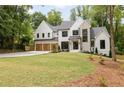 Beautiful home with a manicured lawn, boasting stone, painted brick and siding, plus a three-car garage at 1501 Harts Mill Ne Rd, Brookhaven, GA 30319