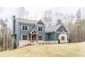 Charming two-story home featuring a well-manicured lawn and classic architectural design at 7636 Chestnut Hill Rd, Cumming, GA 30041