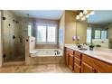 Bright bathroom features double sinks, a soaking tub, and a glass shower at 223 Cheatham Rd, Acworth, GA 30101