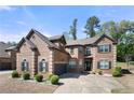 Handsome brick home with attached garage and mature trees, providing a stately presence and serene neighborhood setting at 2745 Veltre Sw Ter, Atlanta, GA 30311