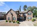 Inviting brick home with well-kept front yard, featuring classic shutters and a welcoming entrance, perfect for a Gathering at 2745 Veltre Sw Ter, Atlanta, GA 30311