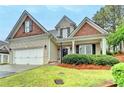 Well-maintained two-story home featuring brick and siding, a manicured lawn, and a two-car garage at 2920 Olde Towne Pkwy, Duluth, GA 30097