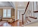 Bright and airy foyer with hardwood floors, a staircase, and views to a living room at 2920 Olde Towne Pkwy, Duluth, GA 30097