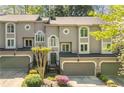 Charming townhome with beautiful architectural details and a well-manicured front yard at 1209 Brookhaven Woods Ne Ct, Brookhaven, GA 30319