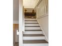 Staircase with white risers and neutral walls, leading to the upper level at 1209 Brookhaven Woods Ne Ct, Brookhaven, GA 30319