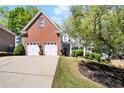 Inviting two-story brick home with a two-car garage and manicured lawn at 561 Valleyside Dr, Dallas, GA 30157