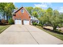 Charming two-story brick home featuring a two-car garage and well-maintained landscaping at 561 Valleyside Dr, Dallas, GA 30157