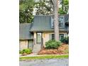 Charming townhome features a brick facade, gray trim, and well-maintained landscaping at 102 Adrian Nw Pl, Atlanta, GA 30327