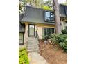 Charming townhome featuring a well-manicured front yard and traditional architectural details at 102 Adrian Nw Pl, Atlanta, GA 30327
