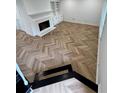 Bright living room with sleek herringbone floors, a cozy fireplace, and built-in shelving at 102 Adrian Nw Pl, Atlanta, GA 30327