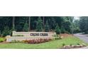 A beautiful stone sign welcomes residents and guests to Cross Creek with manicured landscaping at 102 Adrian Nw Pl, Atlanta, GA 30327