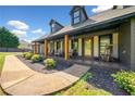 Charming brick home with a welcoming covered front porch and well-manicured landscaping at 3919 Evans Rd, Cumming, GA 30040