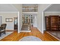 Grand foyer with hardwood floors, high ceilings, staircase, and natural light at 6690 Stillmeadow Dr, Cumming, GA 30040