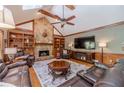 Spacious living room boasts a stone fireplace, built-in bookshelves, and vaulted ceilings with wood trim at 255 Sageglen Rd, Lawrenceville, GA 30044