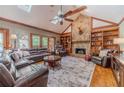 Inviting living room with stone fireplace, high ceilings, ceiling fan, skylights, and hardwood floors at 255 Sageglen Rd, Lawrenceville, GA 30044