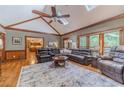 Open concept living room with hardwood floors, large windows, and vaulted ceilings at 255 Sageglen Rd, Lawrenceville, GA 30044
