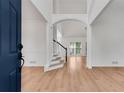Bright entryway with wood floors, high ceilings, and open staircase at 4414 Aldenham Nw Way, Suwanee, GA 30024