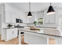 Beautiful kitchen featuring white cabinets, granite countertops and stainless steel appliances at 4414 Aldenham Way, Suwanee, GA 30024