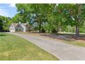 Two-story home with light-blue siding and a long driveway leading up to the garage and home at 4531 Cedar Dr, Loganville, GA 30052