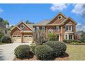 Attractive brick home boasts a two-car garage, well-manicured bushes, and a welcoming entrance at 5222 Camden Lake Nw Pkwy, Acworth, GA 30101
