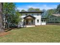 Two-story home with a welcoming front porch and a neatly landscaped lawn at 917 Derrydown Way, Decatur, GA 30030