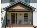 Close-up of a charming front porch with gray railings and a cozy, inviting atmosphere at 917 Derrydown Way, Decatur, GA 30030