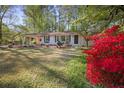 Charming single-story home with white brick and colorful shrubbery at 1384 Windburn Dr, Marietta, GA 30066