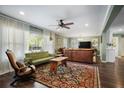 A spacious living room with neutral walls, dark wood floors, and a ceiling fan at 1384 Windburn Dr, Marietta, GA 30066