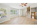 Open living room with natural light, new flooring, and staircase access at 1900 Foster Trace Ct, Lawrenceville, GA 30043